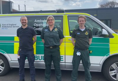 Three advanced paramedics standing in front of the mental health emergency response vehicle