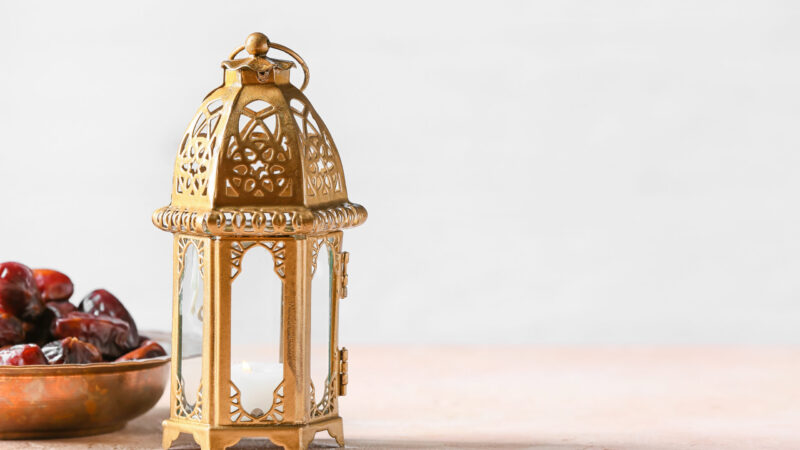 Muslim lamp and dates on light background