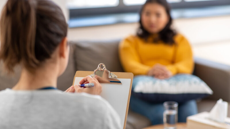 psychology, mental therapy and people concept - close up of woman psychologist and patient at psychotherapy session
