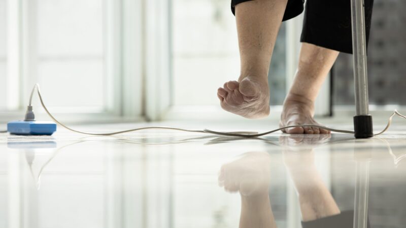 Electrical,Cord,Or,Socket,Cluttered,On,The,Floor,feet,Of,Senior