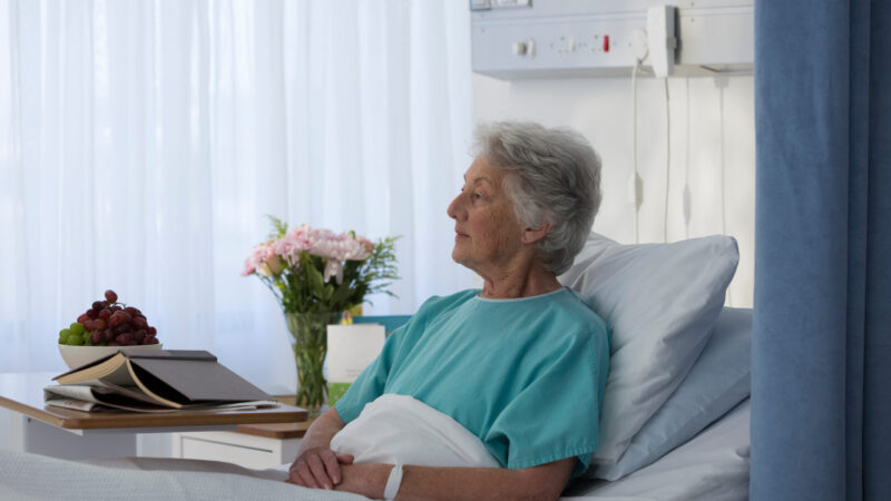 Thoughtful female senior patient in hospital bed